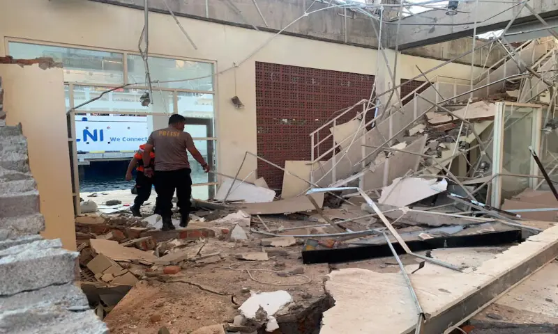 Rescuers inspect a heavily-damaged building at L. Say port following an earthquake in Sikka, East Nusa Tenggara province, Indonesia. -- Reuters
