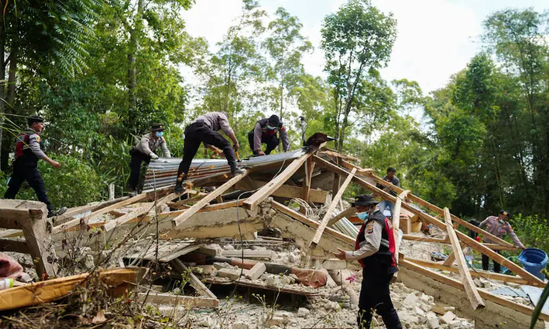 Police officers inspect a heavily-damaged house in Manggarai, East Nusa Tenggara province, Indonesia, on Sunday. --- Reuters