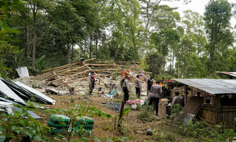 Police officers inspect a heavily-damaged house after an earthquake was felt in Manggarai, East Nusa Tenggara province, Indonesia. -- Reuters