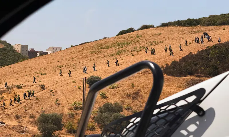 Moroccan security personnel search a hillside during an operation to locate migrants potentially attempting to cross irregularly into the Spanish enclave of Ceuta, in Fnideq, Morocco. -- Reuters