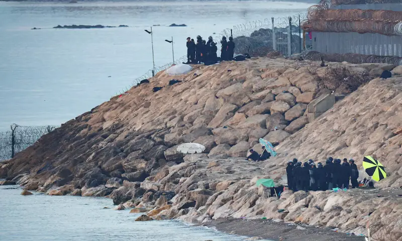 Moroccan security personnel secure the beach on the border with Spain in Ceuta. -- Reuters
