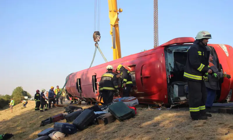 Firefighters work at the scene of a deadly accident near Mezokeresztes, Hungary. -- Reuters