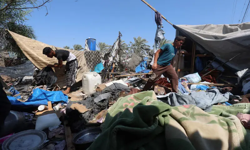 Palestinians inspect the site of an Israeli strike on a tent in Khan Younis, in the southern Gaza Strip. -- Reuters
