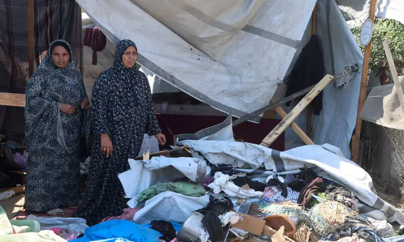 Palestinian women inspect the site of an Israeli strike on a tent in Khan Younis in the southern Gaza Strip. -- Reuters