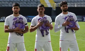 Iranian soccer players hold schoolbags in solidarity with slain girls