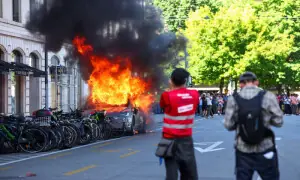 Protesters set Tesla ablaze, smash UN office's windows in Geneva anti-G7 march Protesters set Tesla ablaze, smash UN office's windows in Geneva anti-G7 march