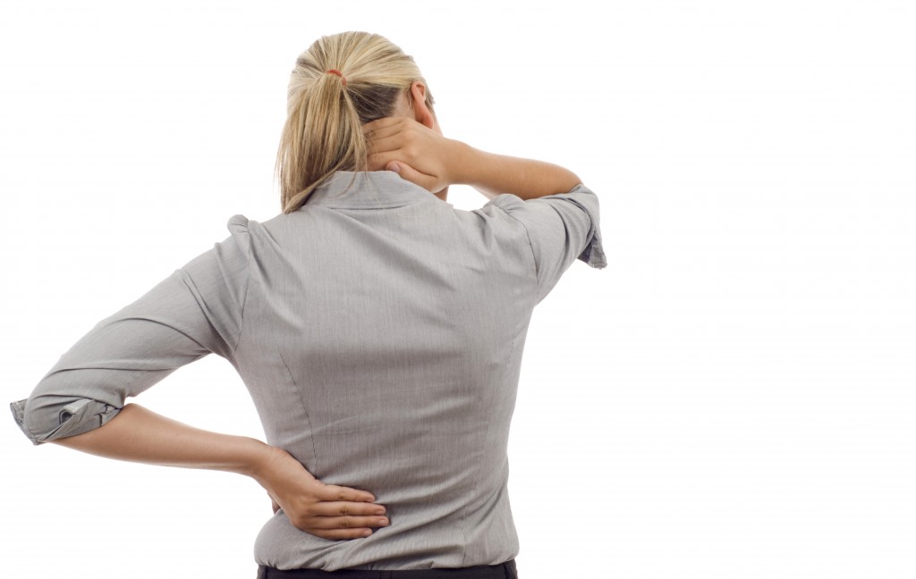 Woman with back pain isolated over a white background