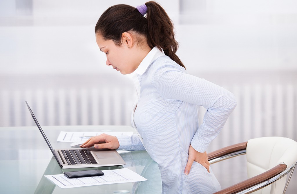 Yoga Parivrtta Parsvakonasana twisting pose by fit man in white trousers on the drought earth in yoga shala, Varkala, Kerala, India