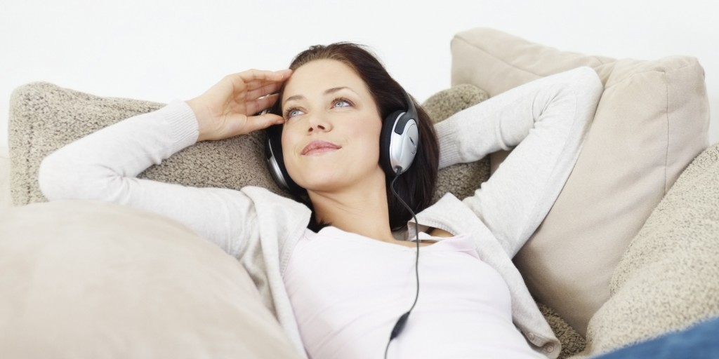 Young girl listening to music at home