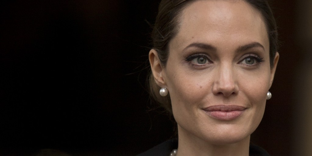 Angelina Jolie looks to the media as she leaves a G8 Foreign Ministers meeting on sexual violence against women in London, Thursday, April, 11, 2013. The ministers are meeting in London as Britain currently holds the G8 Presidency, with the heads of government G8 meeting set for June in Northern Ireland.(AP Photo/Alastair Grant)